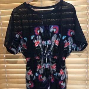 Black mesh dress with embroidered flowers.